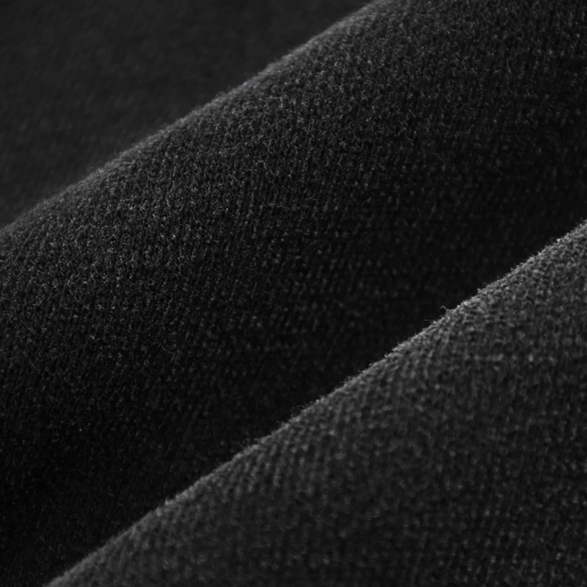 Textured black fabric close-up showcasing premium quality for sweatpants collection.